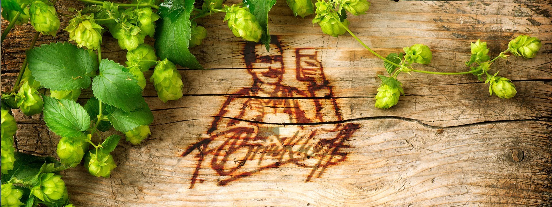 The face of F. Brinkhoff branded onto wood, surrounded by hops.